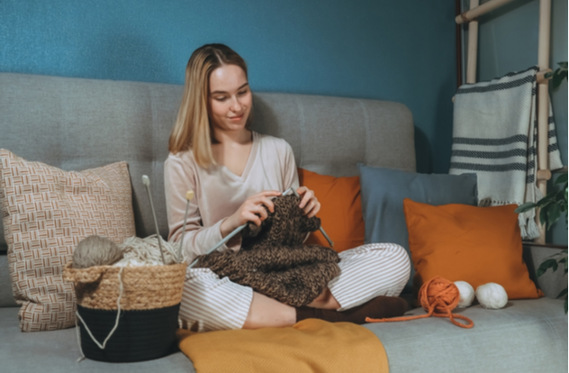 Girl knitting at home
