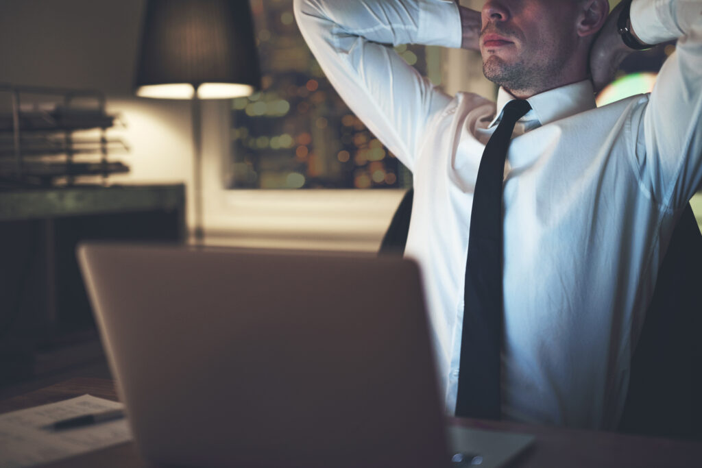 lawyer sitting at desk, working at night, grappling with burnout, mental health and substance use challenges