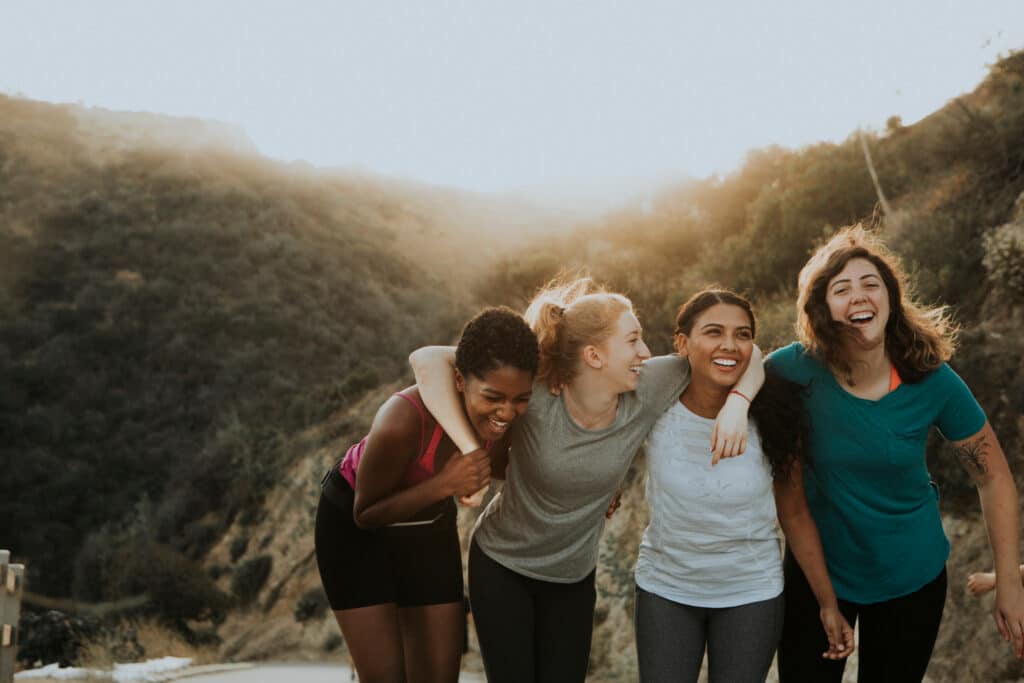 Women hugging each other and smiling as they heal in alcohol and substance abuse rehab together