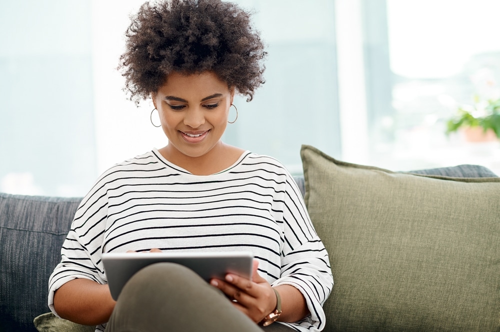 A woman sitting on the couch participating in a virtual IOP in Utah