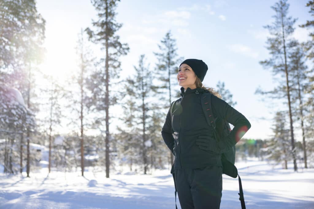 A person hiking in the snow-covered mountains of Park City, Utah, representing renewal and recovery in the new year.