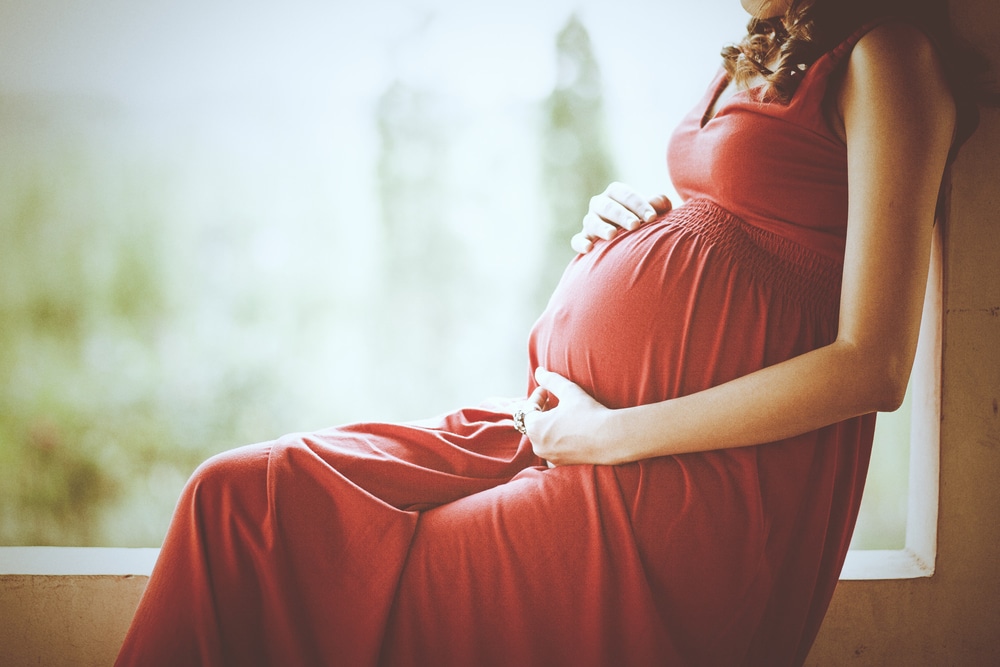 A pregnant woman holding her belly