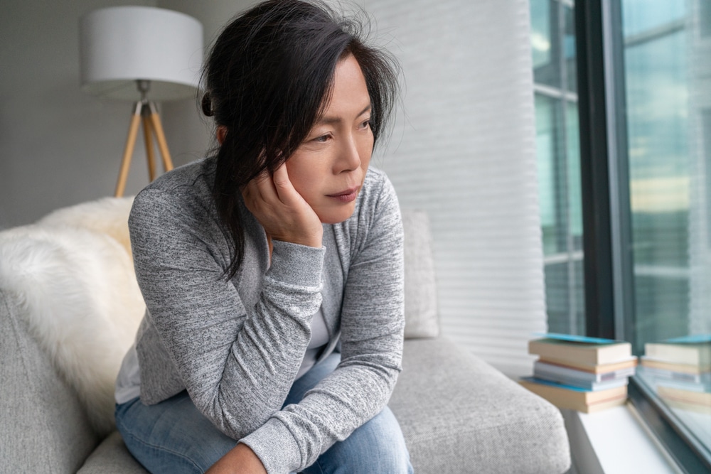 A woman feeling homesick during out-of-town addiction treatment
