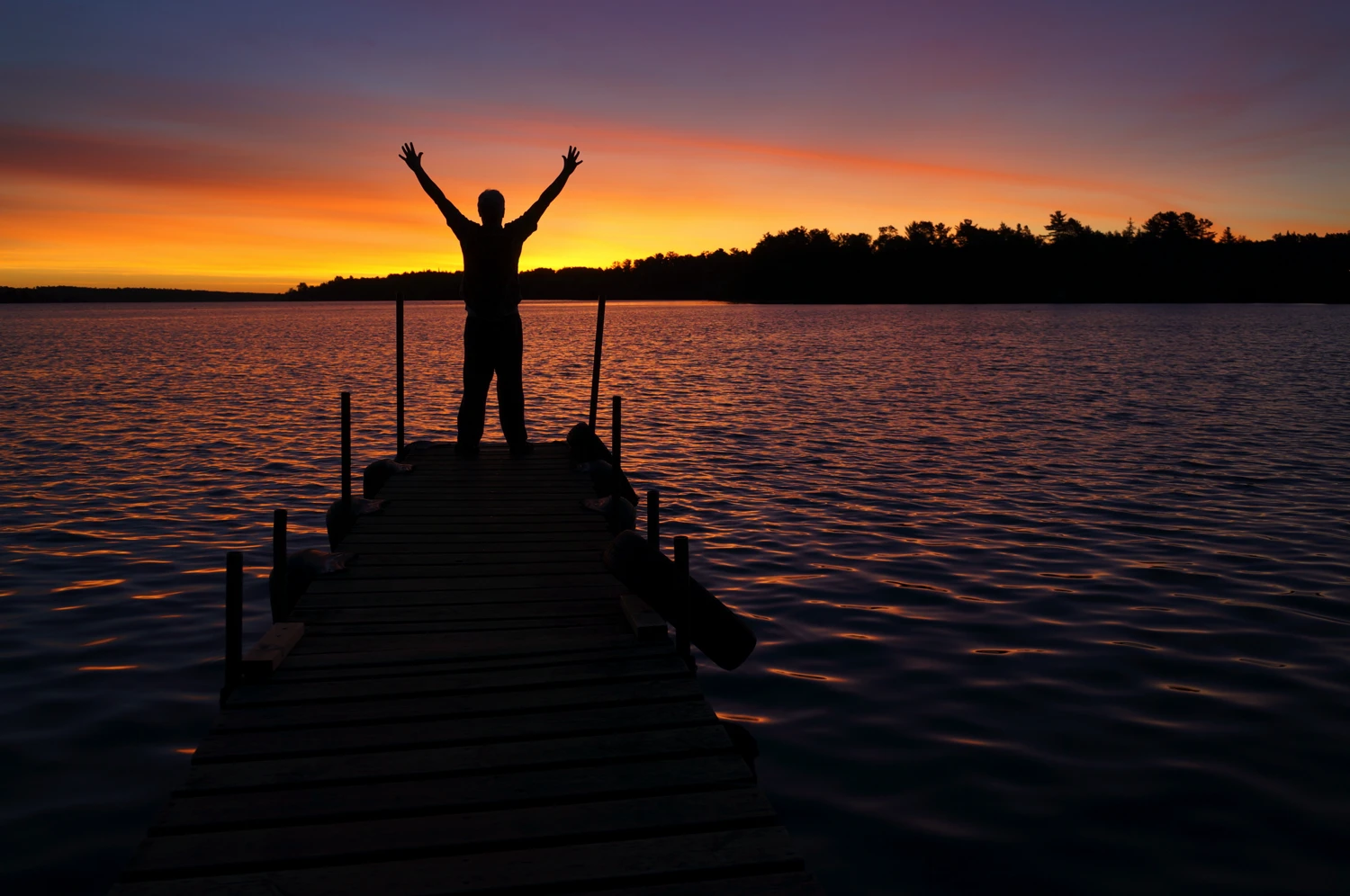 A person raising their arms in victory in completing the 12 steps of AA