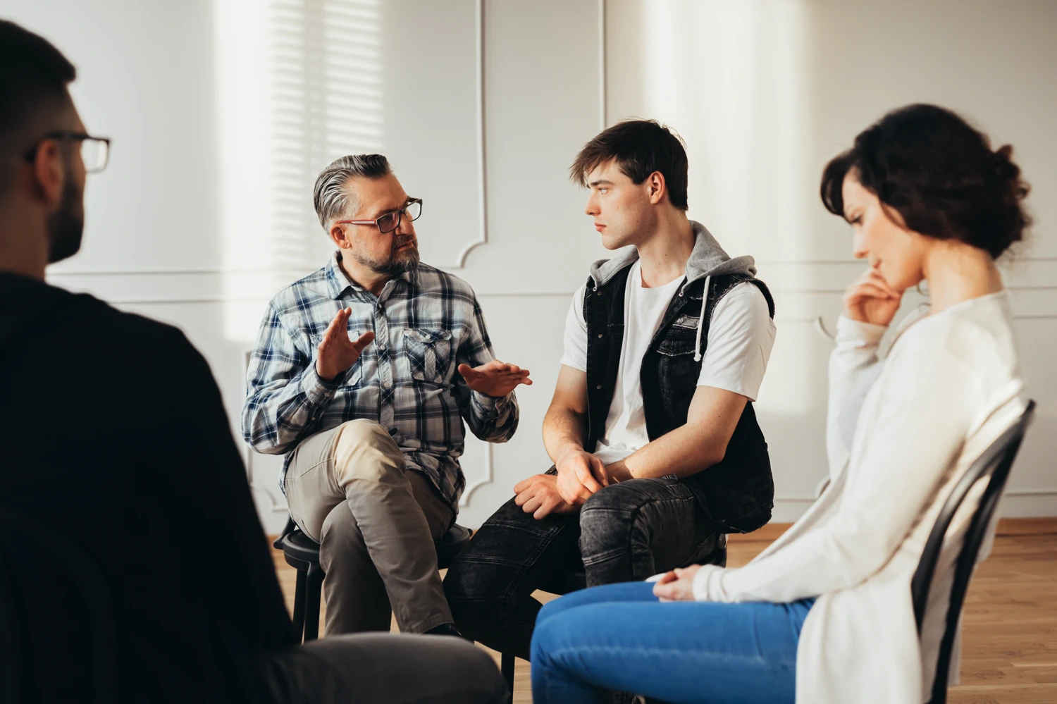 A therapist working with a group going through the 12 steps of AA